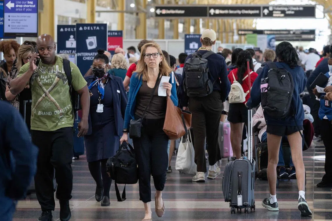 Passengers check in for their flights at the start of the Memorial Day weekend in the US, at Reagan National Airport in Arlington, Virginia.