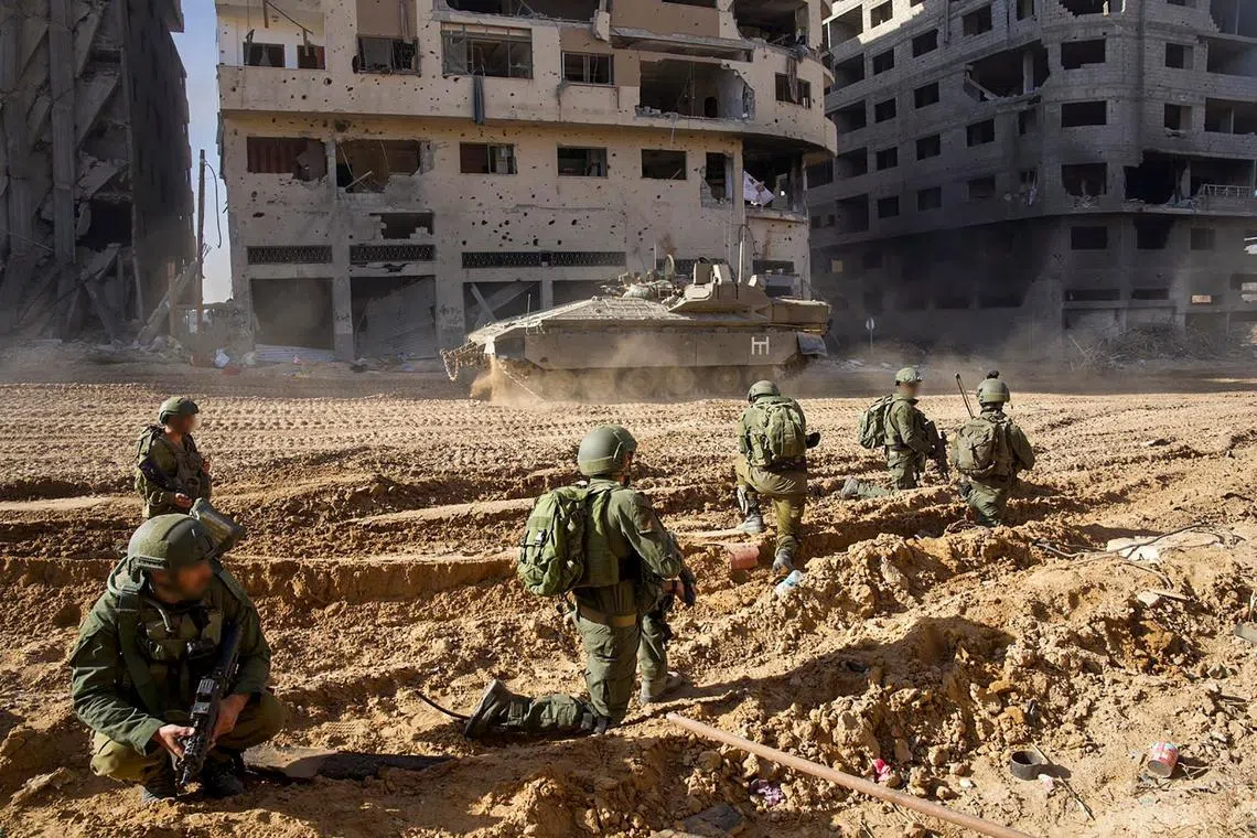 Israeli army troops on the ground on the Gaza Strip on Dec 7, 2023, amid continuing battles between Israel and the Palestinian militant group Hamas. 