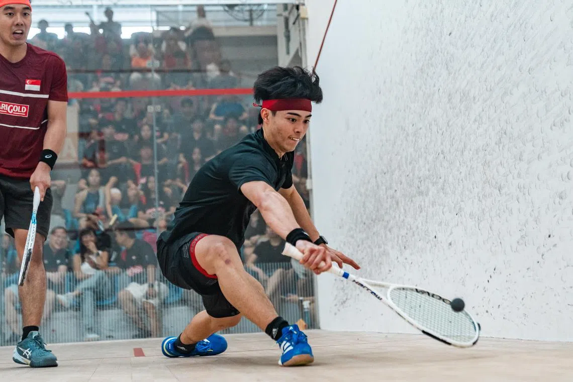 Aaron Liang (right) defeated top seed Jerome Aw to clinch his first Singapore national squash title.