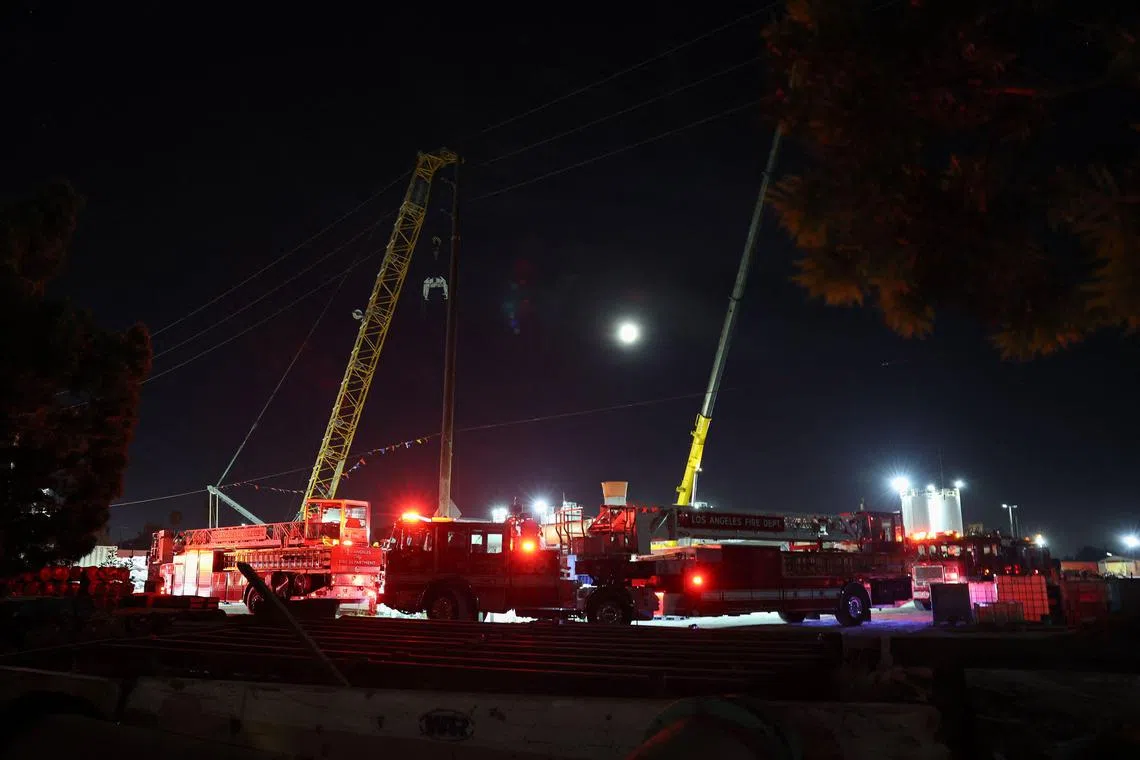 Los Angeles Fire Department (LAFD) vehicles are seen at the site of an industrial tunnel collapse in the Wilmington neighbourhood of Los Angeles.