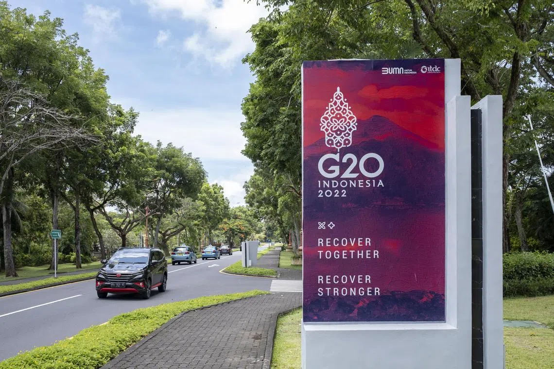 A car drives past a G20 banner near the venue of G20 in Nusadua, Bali, Indonesia, 25 October 2022. Indonesia will use around 500 electric cars as the official vehicle during the G20 Summit in Bali in 2022. The aim is to encourage the broader use of alternative energy-based vehicles in Indonesia. Bali will host the 17th Group of 20 (G20) Heads of State and Government Summit on 15 and 16 November 2022.  EPA-EFE/MADE NAGI