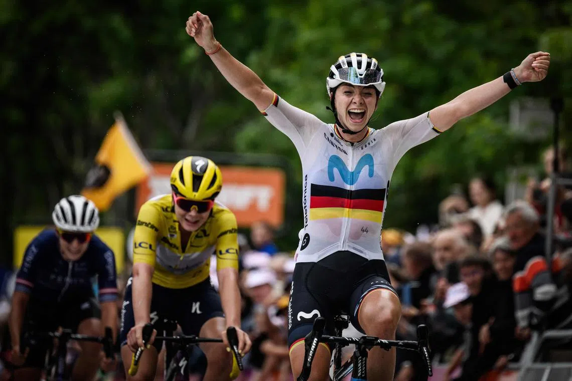 Movistar's German rider Liane Lippert, flanked by SD Worx's Lotte Kopecky, crossing the finish line as she wins the second stage of the second edition of the Women's Tour de France.