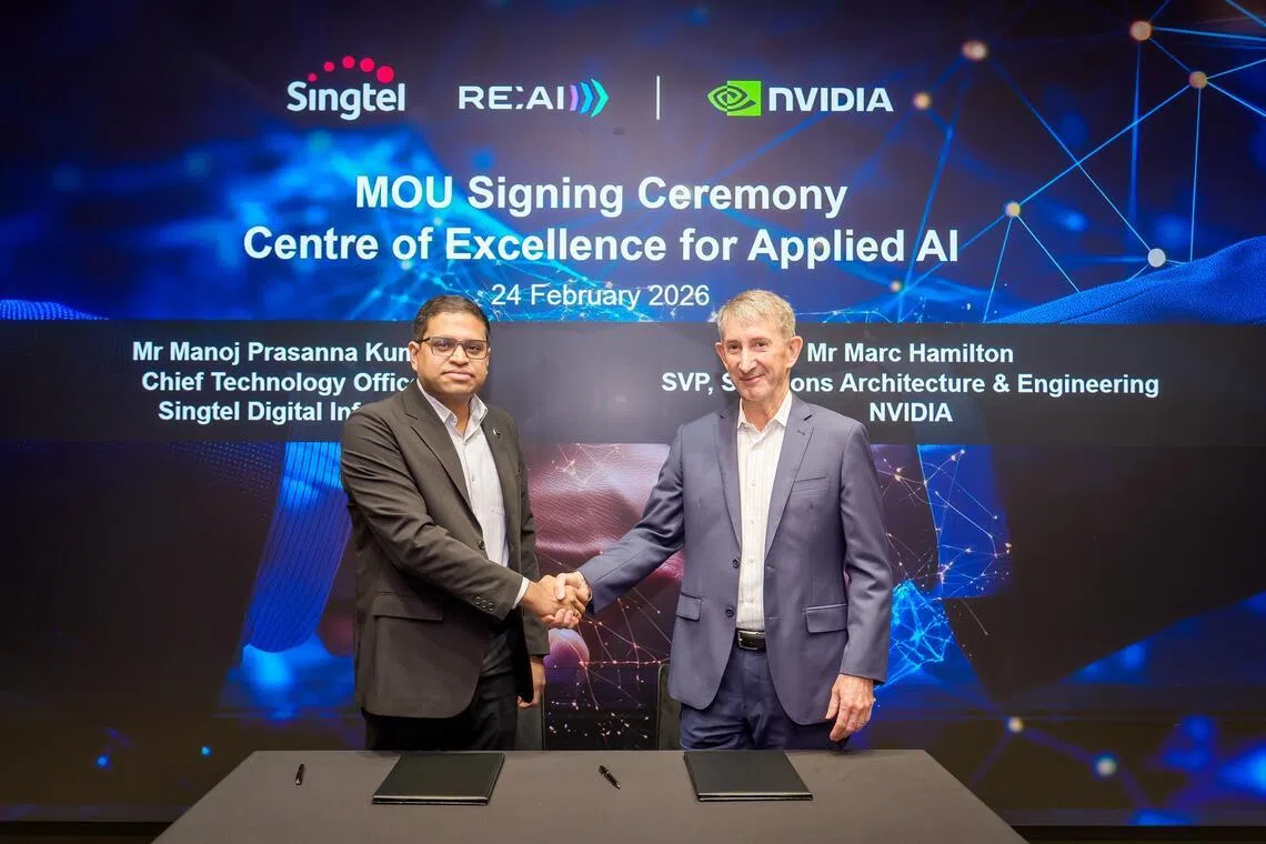 A handshake to tie the launch of their Centre of Excellence for Applied AI.  (From left) Mr Manoj Prasanna Kumar , chief technology officer (CTO) of Singtel Digital InfraCo and Nvidia’s senior vice‑president of solutions architecture and engineering Marc Hamilton.

PHOTO: SINGTEL