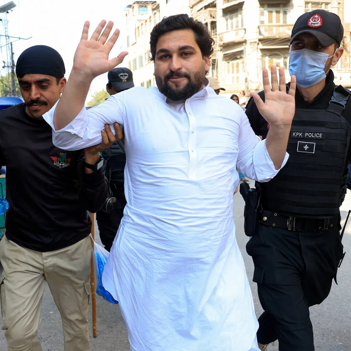 Police officers detain a protester following a protest call by supporters of jailed former Pakistani Prime Minister Imran Khan's party, Pakistan Tehreek-e-Insaf (PTI), a day after Pakistan imposed a state of emergency in Khyber Pakhtunkhwa province and suspended the provincial government led by Khan's party, in Peshawar, Pakistan, October 12, 2026. REUTERS