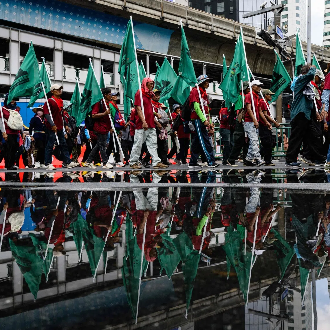 Demonstrators march during a protest against the International Monetary Fund and World Bank Group in Bangkok.