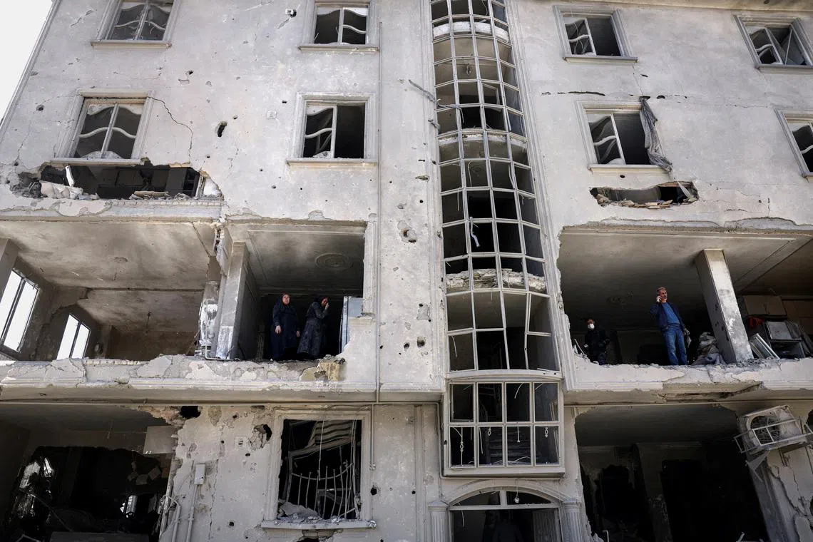 People inspect damage to a residential building after it was hit by a strike, amid the U.S.-Israeli conflict with Iran, in Tehran, Iran, March 30, 2026. Majid Asgaripour/WANA (West Asia News Agency) via REUTERS