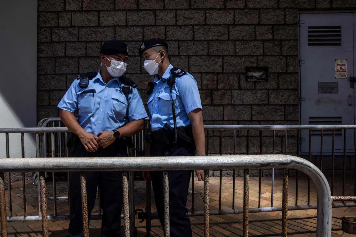Police stand guard before the departure of a pro-democracy activist from Hong Kong's high court in this Aug 22, 2022, file photo.  Beijing's national security office in the city was set up following huge, and sometimes violent, democracy protests.