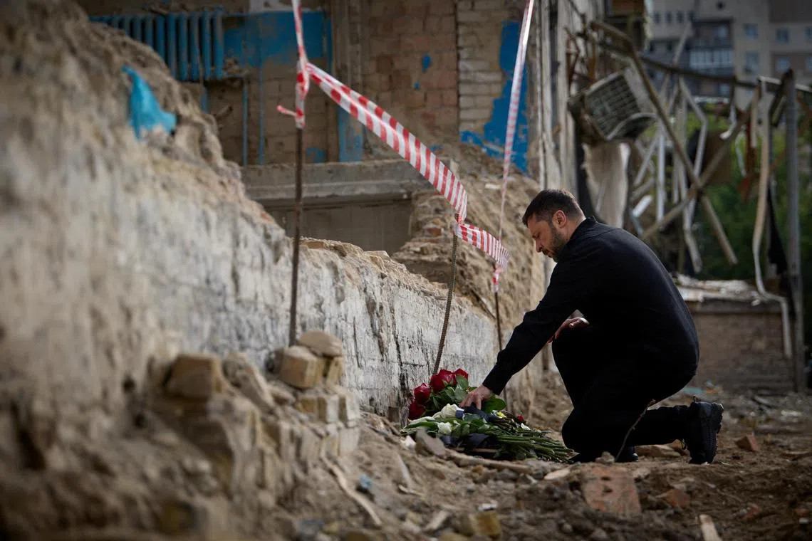 Ukrainian President Volodymyr Zelensky paying tribute on June 19 to the 28 people who died in drone and missile strikes by Russia on June 17.