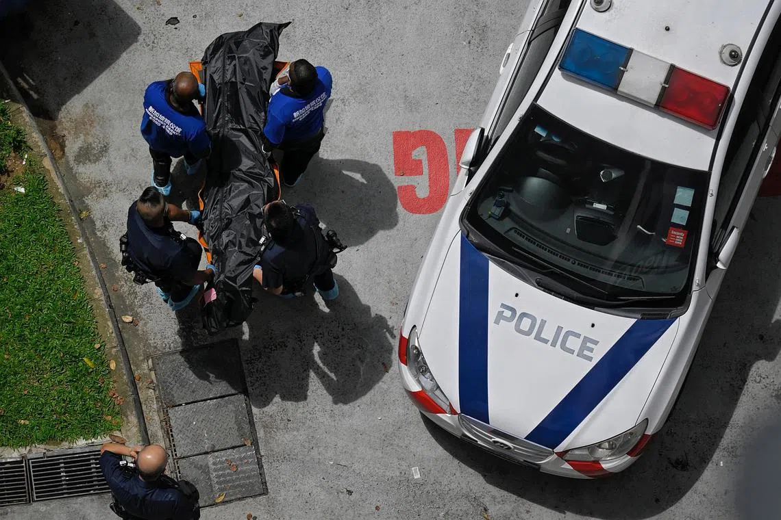 Officers removing the body of Mr Tan Ah Bang after he was found lying motionless in his flat in Sengkang on Nov 4, 2022.