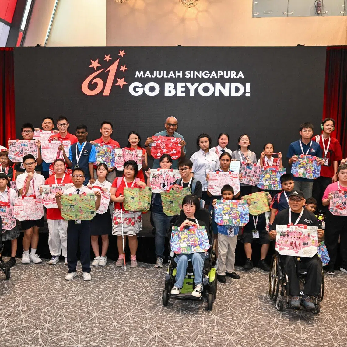 President Tharman Shanmugaratnam with artists behind the artworks for this year’s NDP pack at the National Stadium on June 30.