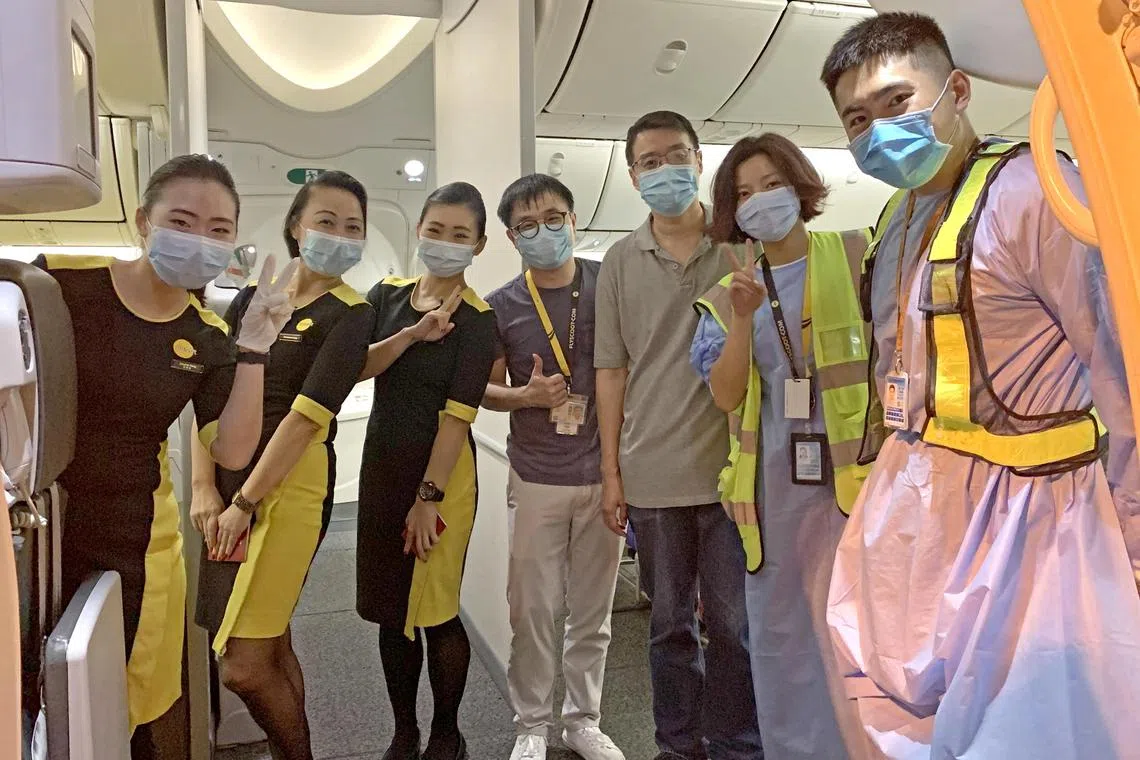 Scoot station manager and Wuhan native Albee Yao (second from right) helped to process passengers at check-in for rescue flight TR5120 on Feb 9, 2020.