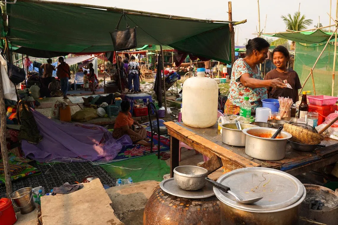 People are seen inside a shelter in a makeshift tent camp following a strong earthquake in Amarapura township, Myanmar, on April 4.