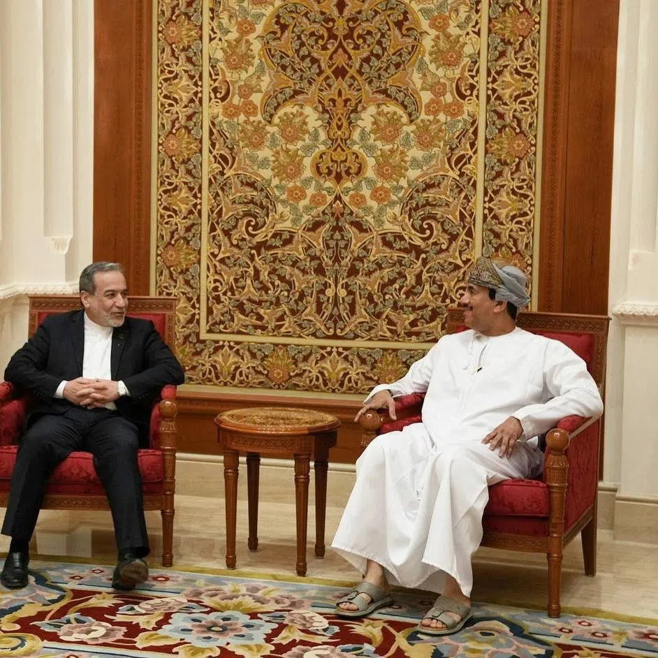 Iran's Foreign Minister Abbas Araghchi is welcomed by an Omani official upon his arrival in Muscat, Oman, on Feb 6.