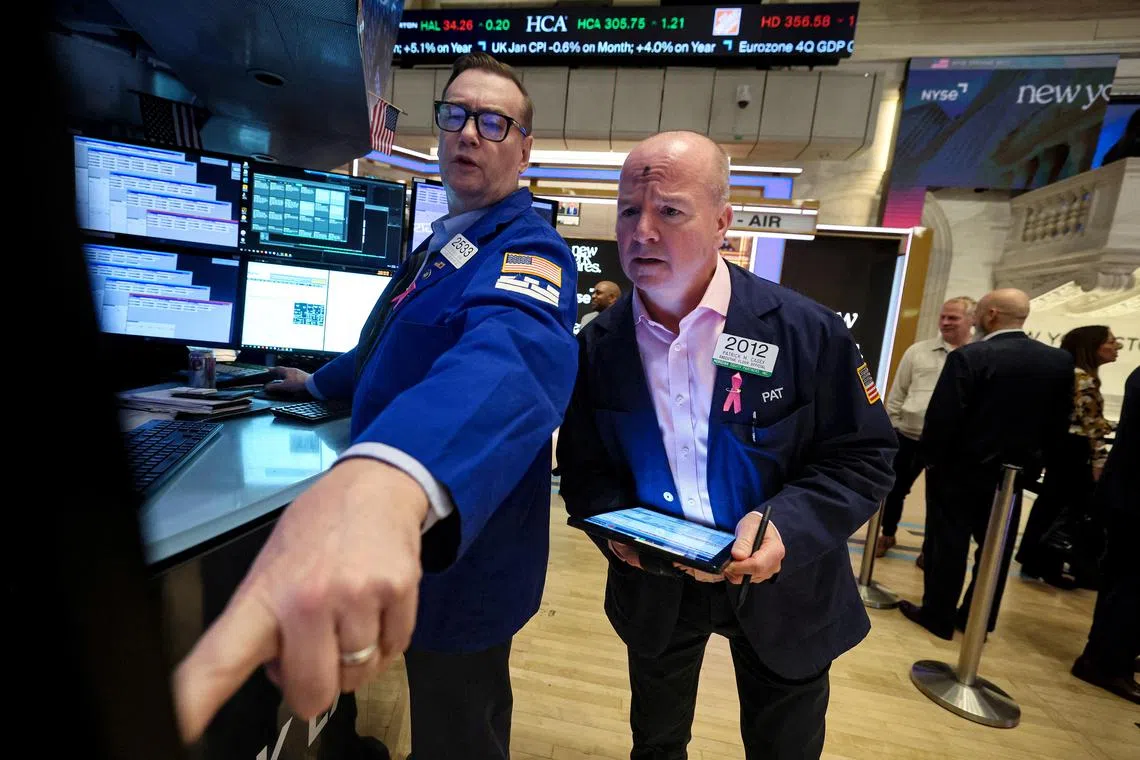 Traders work on the floor of the New York Stock Exchange, in New York City.
