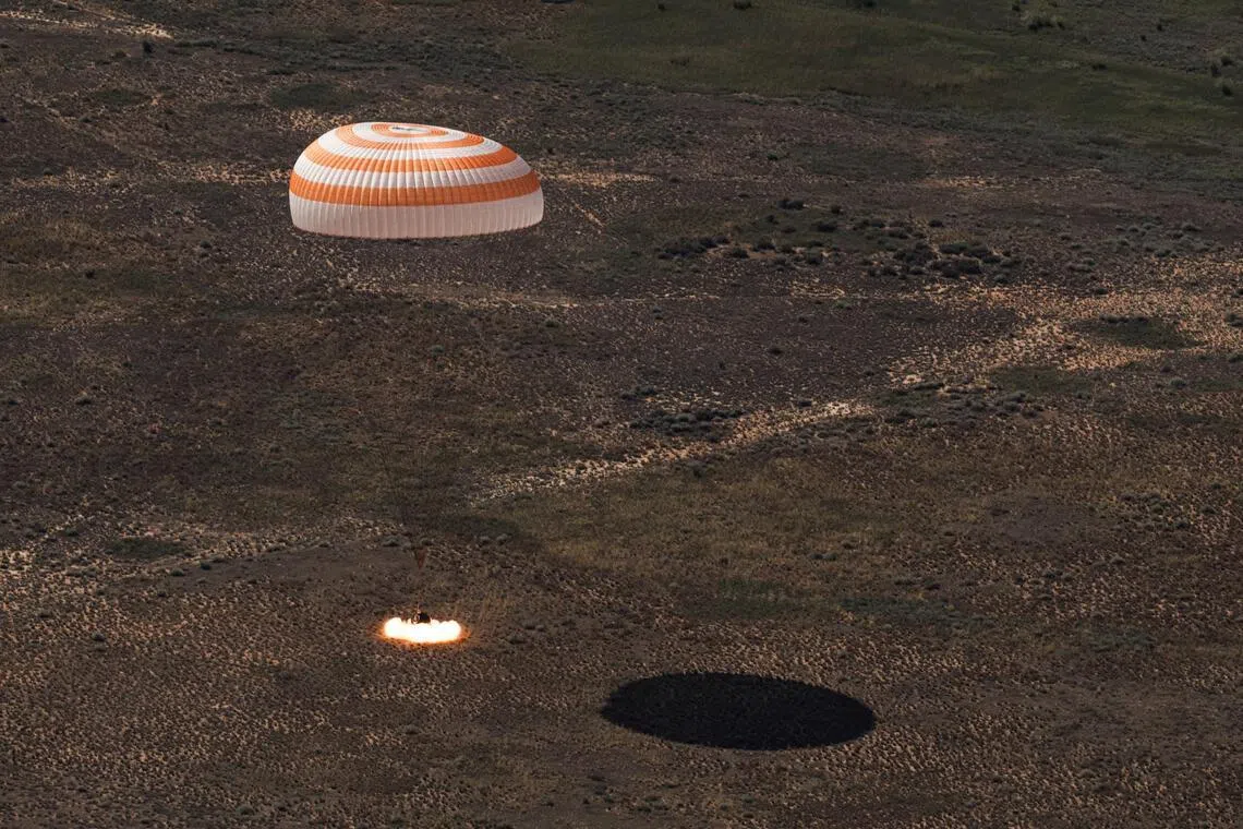 The Soyuz MS-28 capsule carrying the International Space Station (ISS) crew of NASA astronaut Christopher Williams, Roscosmos cosmonauts Sergey Kud-Sverchkov and Sergey Mikaev lands in a remote area near Zhezkazgan, Kazakhstan, July 26, 2026. Roscosmos/Handout via REUTERS ATTENTION EDITORS - THIS IMAGE HAS BEEN SUPPLIED BY A THIRD PARTY. MANDATORY CREDIT.