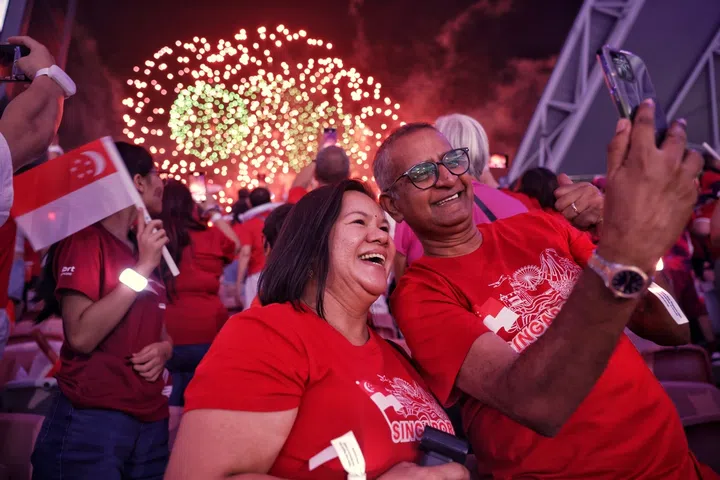 Spectators watch the finale of National Day Parade (NDP) 2026 at the National Stadium.