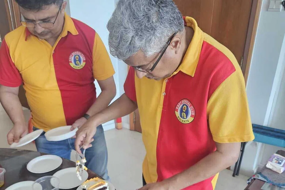 The cake being cut and distributed.