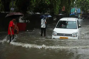 A car moves through a flooded street after heavy rains in Mumbai on July 1.