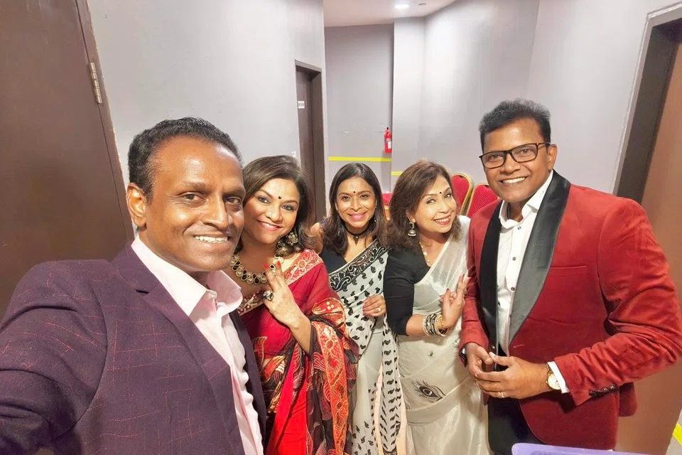Victor Punithan (right) with other artistes and emcee Mano Manikkam (left) who performed on stage.