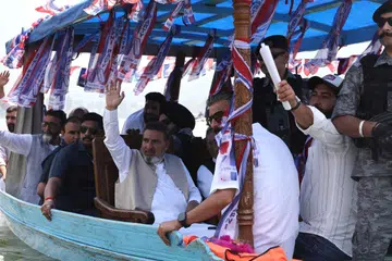 Apni Party President Altaf Bukhari (centre, with raised hand) leading the boat rally at the Dal Lake in Srinagar.