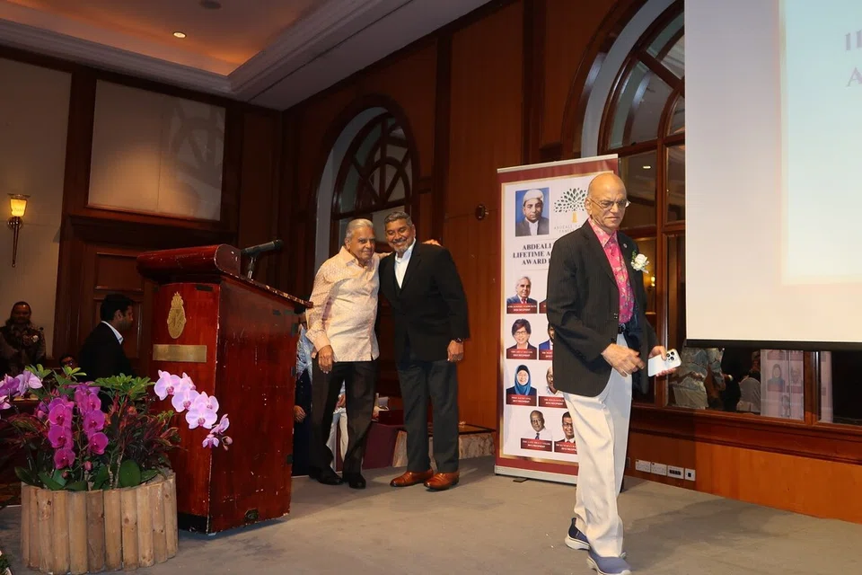Prof Kishore Mahbubani with Mr Viswaroopan Sadasivan, with Mr Ameerali Abdeali in the foreground.