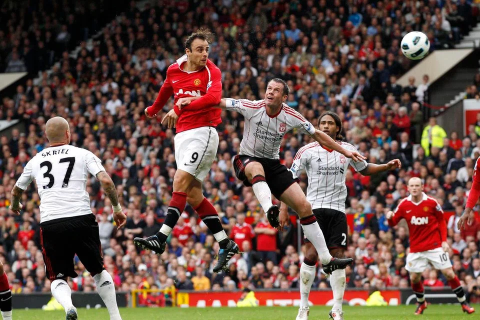 Dimitar Berbatov (in red) scoring for Manchester United against Liverpool  in the English Premier League.