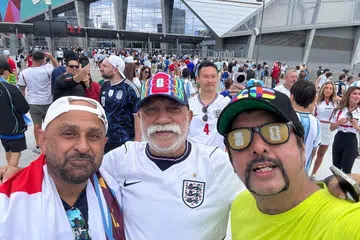 Raspal Singh Sidhu (in green) with friends at the England-Argentina match; Sunil Laungani (raised hand) celebrating Spain’s victory; Malminderjit Singh with the Singapore flag.
