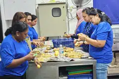 Volunteers from the LISHA Women’s Wing helping with meal preparation at Krishna Free Meals. 