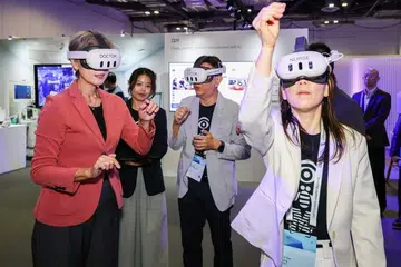 (From left) Minister for Digital Development and Information Josephine Teo, guided by IBM cognitive solution developer Richard Wo and IBM senior data scientist Ang Ai Kiar, trying IBM’s immersive mixed reality training solution, developed with Changi General Hospital, at the IBM Think Singapore conference on July 21.