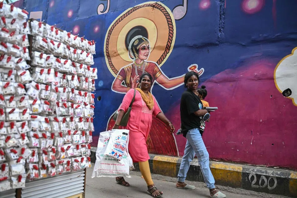 People walk past a roadside shop in Chennai on Aug 6, 2026.