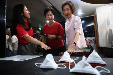 Minister for Sustainability and the Environment Grace Fu (right) at a mask distribution exercise at Yuhua SMC on Oct 14.