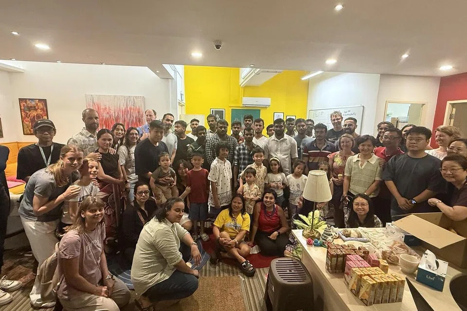 Migrant workers and families at the informal gathering.