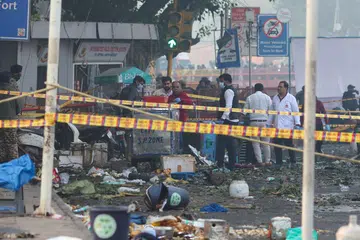Security personnel and members of the forensic team work at the site of an explosion Nov 11.
