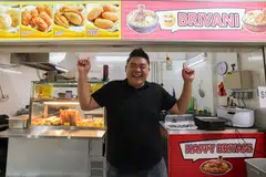 Mr Shaun Ho in front of his hawker stall which sells biryani at $5 a plate and dough fritters.