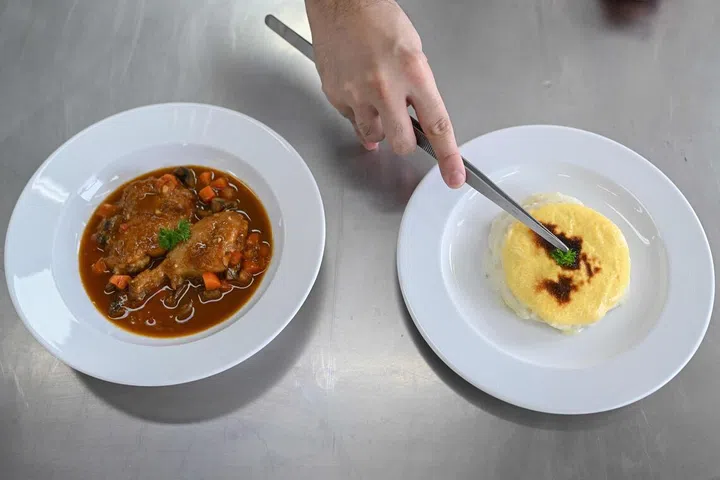 A student chef garnishing a plate of classic French potato dish "Gratin Dauphinois" at the École Ducasse, a French culinary school in Gurugram. French cooking schools in India are attracting a wave of young talent, hungry to reach the upper echelons of international gastronomy and reap the rewards of their country's growing appetite for fine dining.