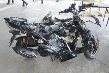 A motorcycle’s bodywork taken apart after ICA officers flagged the vehicle for attempted smuggling of contraband cigarettes in 2025.