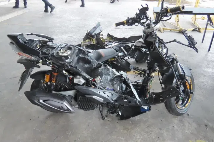 A motorcycle’s bodywork taken apart after ICA officers flagged the vehicle for attempted smuggling of contraband cigarettes in 2025.