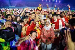 President Halimah Yacob posing for a wefie with NDP performers.