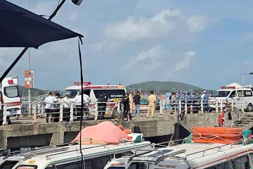 Ambulances line up on a pier to help victims of a boating accident