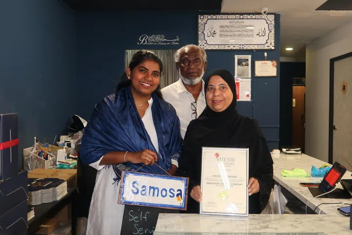 (From left) House of Samosas’ business manager Najeera Roseni, owner Haja Nizamuddeen and founder Noorul Ayn with the SME 500 plaque.