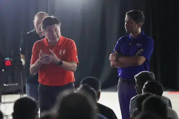 NTUC secretary-general Ng Chee Meng (left) and Minister of State for Manpower Dinesh Vasu Dash speaking to migrant workers affected by the alleged unpaid wages involving KPA Engineering and SK Industries at Tuas View Dormitory on June 24.