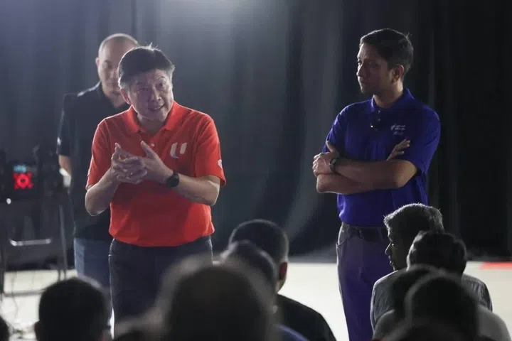 NTUC secretary-general Ng Chee Meng (left) and Minister of State for Manpower Dinesh Vasu Dash speaking to migrant workers affected by the alleged unpaid wages involving KPA Engineering and SK Industries at Tuas View Dormitory on June 24.
