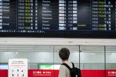 A flight departures board at Haneda Airport on June 1 showing a cancelled flight to Okinawa. More than 320 flights have been cancelled because of Typhoon Jangmi.