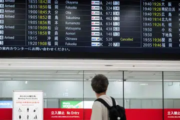A flight departures board at Haneda Airport on June 1 showing a cancelled flight to Okinawa. More than 320 flights have been cancelled because of Typhoon Jangmi.