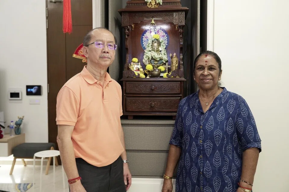 Mr Richard Ho and Madam Dorasamy Radabyee in front of a multi-faith altar. The couple believe that deities from different religions are all manifestations of one god.