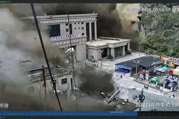 A CCTV footage shows people running away as wall of mud and water destroys buildings in a valley at Nepal-China border, in Gyirong, Tibet region, China August 26, 2026, in this screengrab obtained from a social media video.