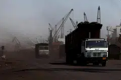 Trucks loaded with coal drive to the coal yard at the Deendayal Port in Kandla, in the western state of Gujarat, India
