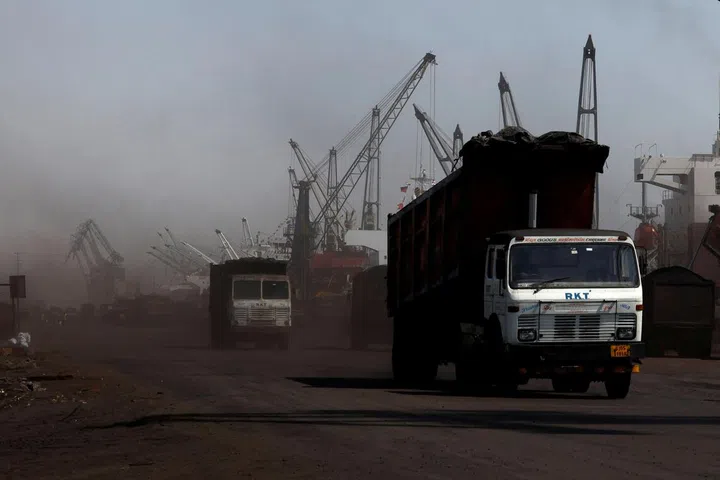 Trucks loaded with coal drive to the coal yard at the Deendayal Port in Kandla, in the western state of Gujarat, India