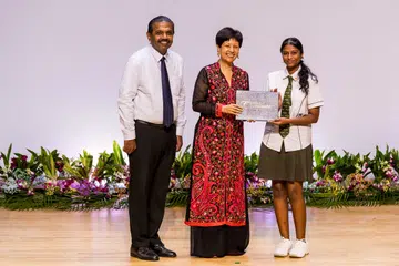 Minister in the Prime Minister’s Office Indranee Rajah (centre) presented a Special Achievement Award to Changkat Changi Secondary School student Priska Roshini Richard Ravi, who created an AI-powered tutoring app. SINDA Chief Executive Officer Anbarasu Rajendran was also present.