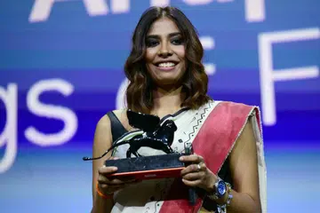 Filmmaker Anuparna Roy with the Orizzonti Award for Best Director she received for Songs of Forgotten Trees at the Venice Film Festival.